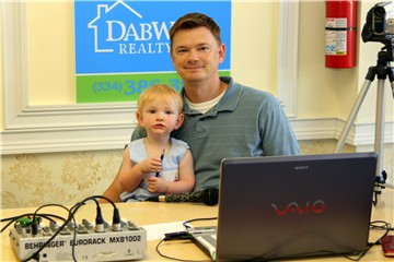 One year old Daniel Butler and Michael on remote broadcast for Tallassee Times TV at Dabwood Realty's Open House